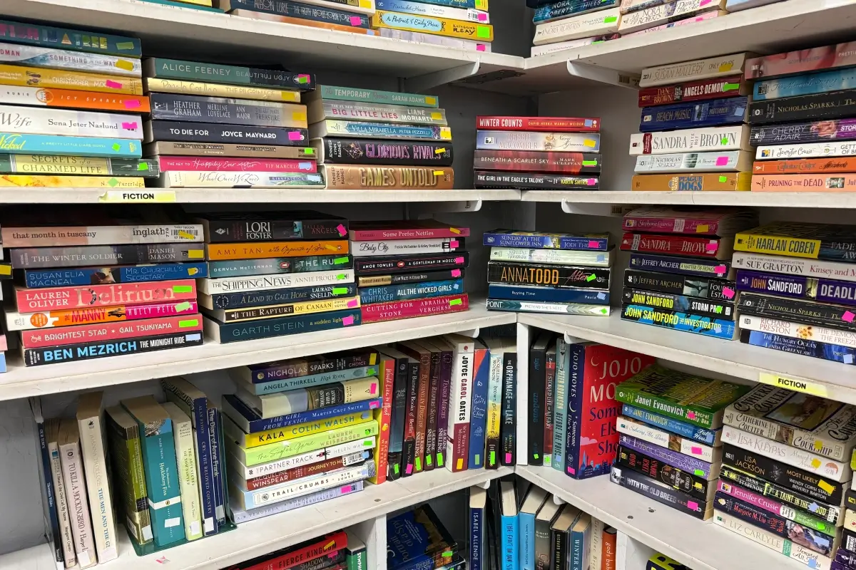 Books arranged on shelves in a thrift store bookstore section