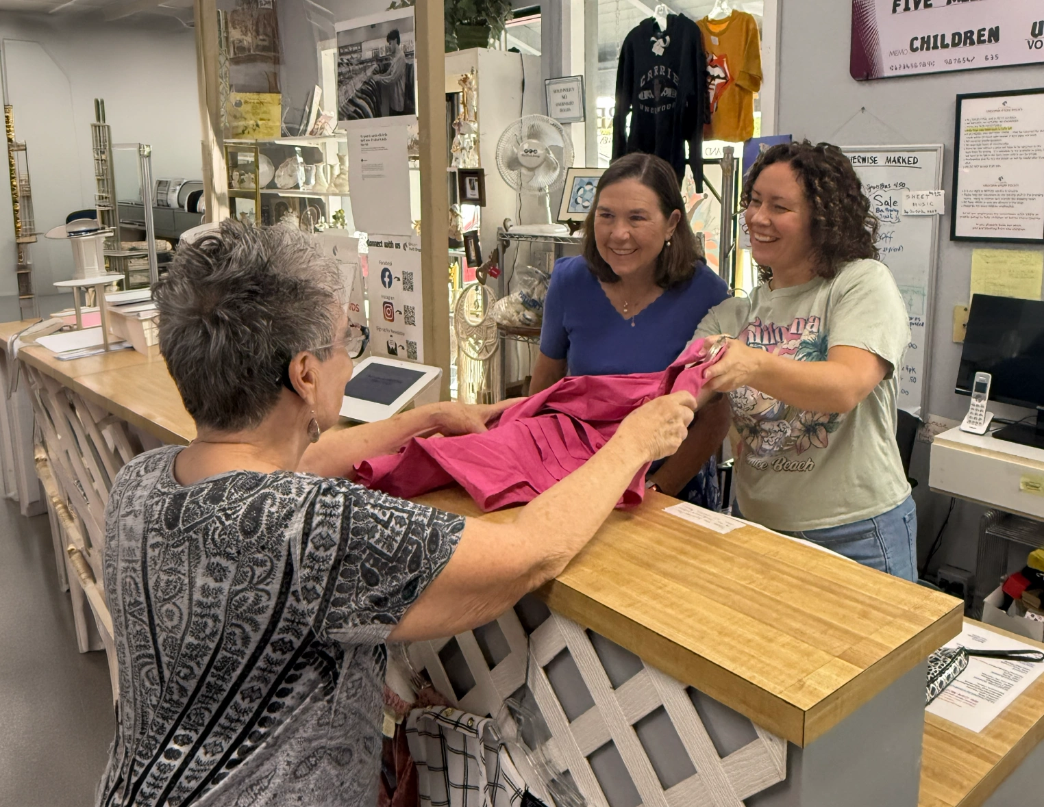 Customer receiving clothing at a thrift shop counter